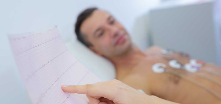 Doctor checking man's heart results